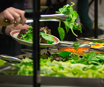 Customer creating her own salad from the bar