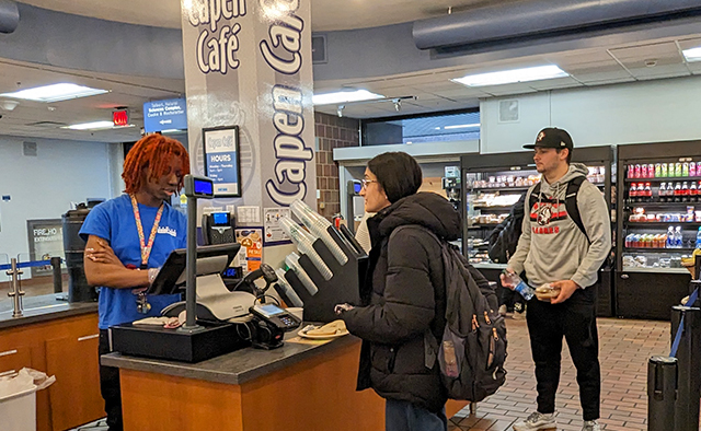 Student ordering from a cashier at Capen Café