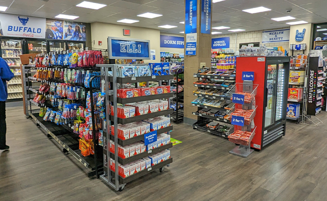Shelves lined with Pocky and other candies, as well as frozen foods in the back freezers