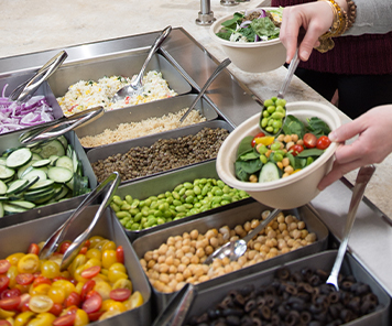 Customer creating their own salad bowl from The Bowl in Harriman Café