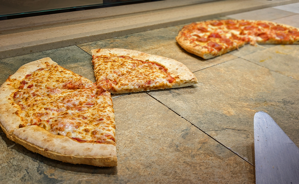 Hubies whole cheese pizza and pepperoni pizza waiting to be served
