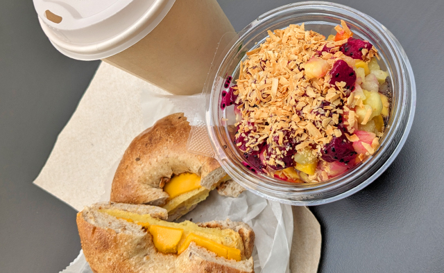 Plant based egg & cheese sandwich on a bagel, dragonfruit acai bowl, and a hot coffee from Seasons