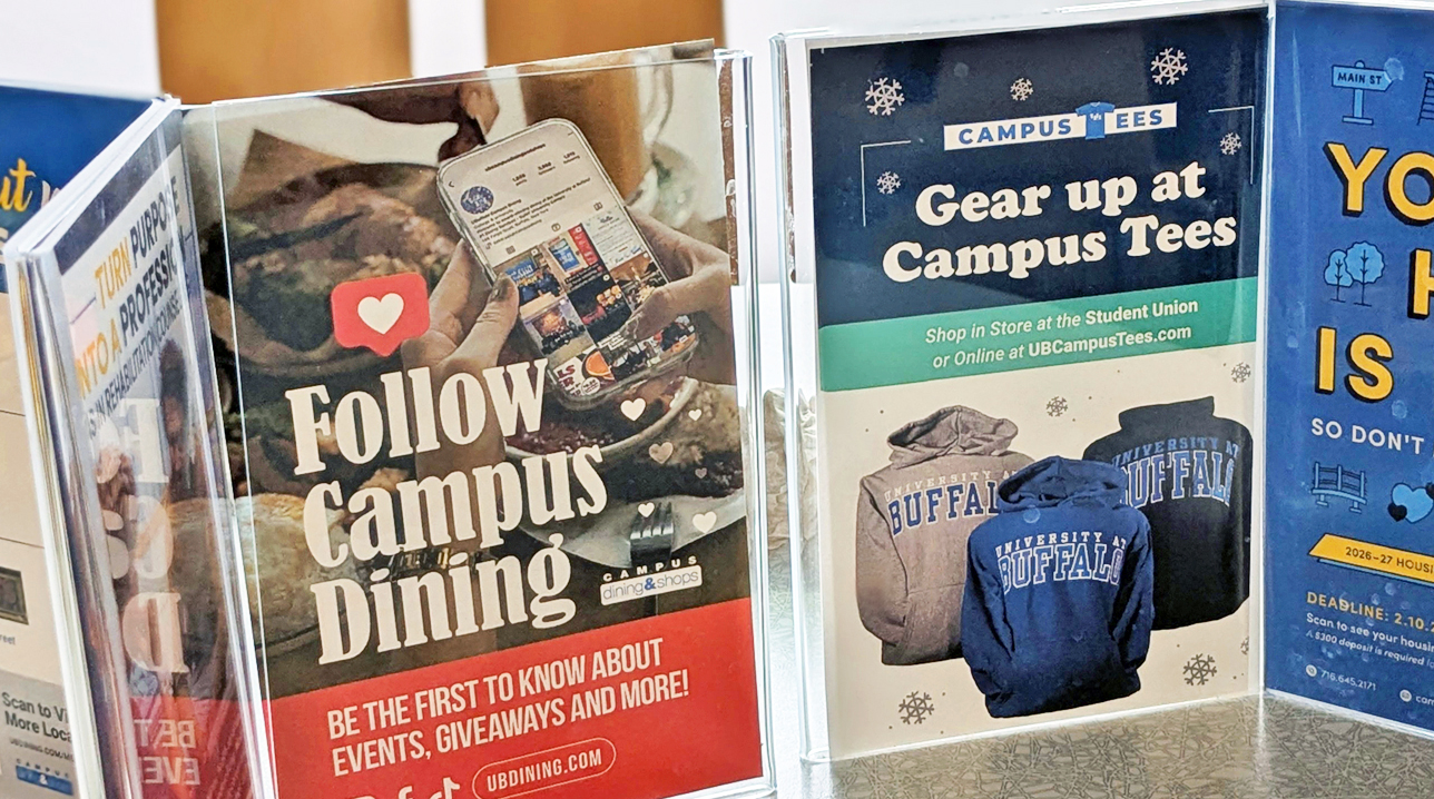 A pair of table tents on a table featuring ads from CDS and Campus Living.