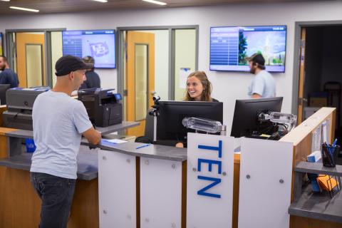 A student talking with an associate at the UB Card section of 1Capen. Photo by Meredith Forrest Kulwicki.