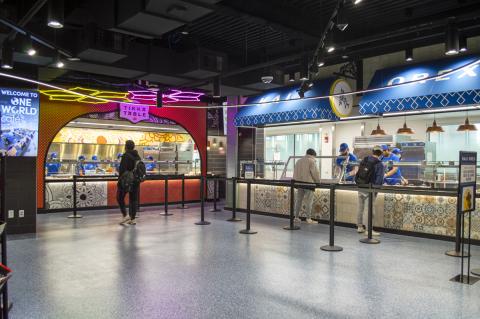 Tikka Table and Kali Orexi are at the right side of One World Café near the entrance.