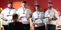 The four chefs on stage presenting their awards