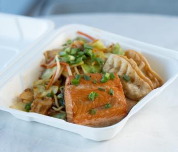 Mirin glazed salmon with rice, hibachi vegetables and gyoza