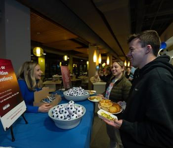 Students talking with our Dietitian Lori Bendersky at the Soccer Event at Crossroads Culinary Center (C3) in Ellicott Complex on North Campus. Photographer: Onion Studio