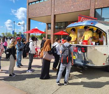 Coca-Cola Throwback truck from the front. Employees serving free Coke floats to students.