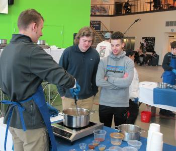 Students participating in Chef Neal Plazio's cooking lesson in the Student Union on North Campus