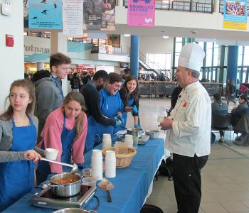 Students participating in Chef Neal Plazio's cooking lesson in the Student Union on North Campus