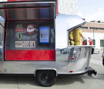 Coca-Cola Throwback truck from the side. Employees serving free Coke floats to students.