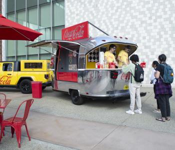 Coca-Cola Throwback truck from the front. Employees serving free Coke floats to students.