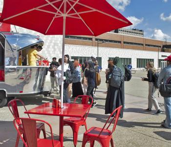 Coca-Cola Throwback truck from the side. Employees serving free Coke floats to students.