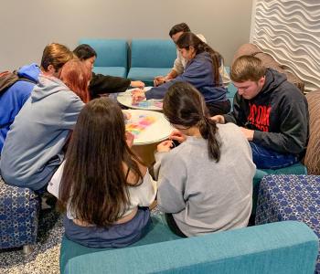 Students making friendship bracelets