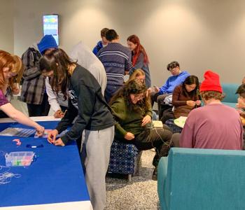 Students making friendship bracelets
