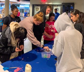 Students making friendship bracelets