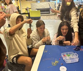 Students making friendship bracelets