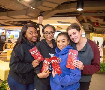 Students posing with their Clue pamphlets