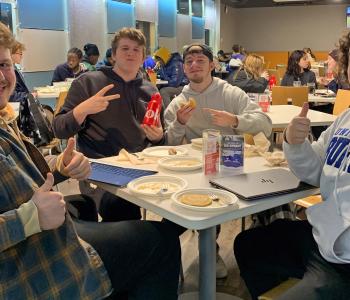 Students seated enjoying pancakes and sausage at Crossroads Culinary Center (C3)