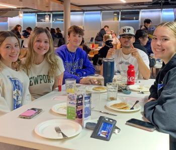 Students seated enjoying pancakes and sausage at Crossroads Culinary Center (C3)