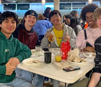 Students seated enjoying pancakes and sausage at Crossroads Culinary Center (C3)