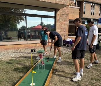 Students playing mini golf