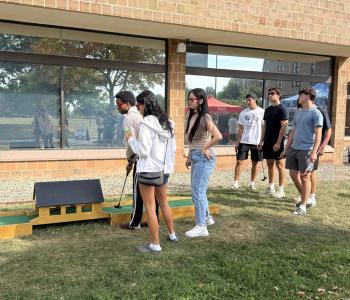 Students playing mini golf