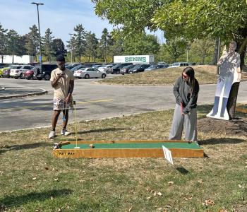Students playing mini golf