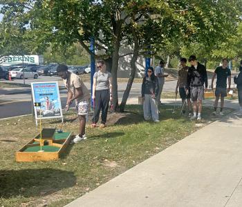 Students playing mini golf
