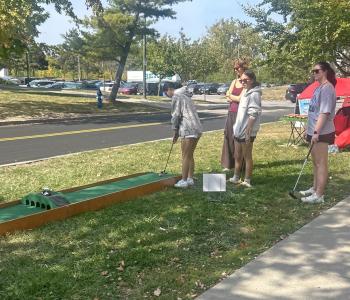 Students playing mini golf