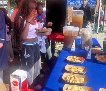 Student getting food at the snack tent