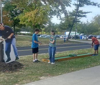 Students playing mini golf