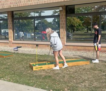 Students playing mini golf