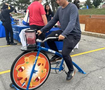Student riding a blender bike