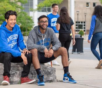 Students wearing apparel from Campus Tees outside of the Center of the Arts. Photo by Onion Studio.