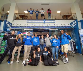 Students wearing apparel from Campus Tees outside of the Tees store in the Student Union. Photo by Onion Studio.