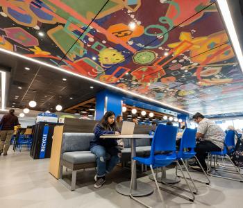 A student doing work in the seating area of One World Café. Photo by Onion Studio.