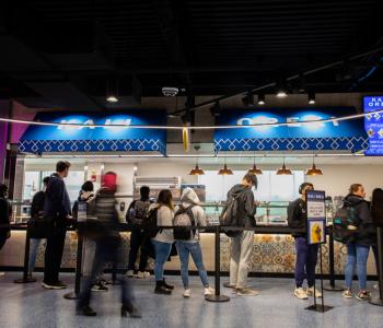 Students in line to order at Kali Orexi at One World Café.