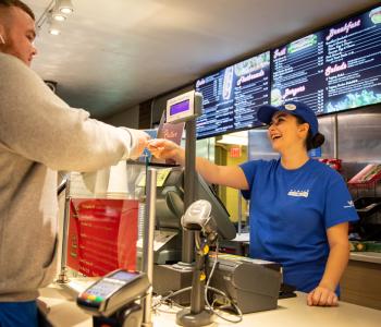 An associate receiving a student's card to pay for their order at The Cellar. Photo by Meredith Forrest Kulwicki.