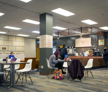 Students eating at tables and ordering at Whispers Café at Abbott Library. Photo by Douglas Levere.