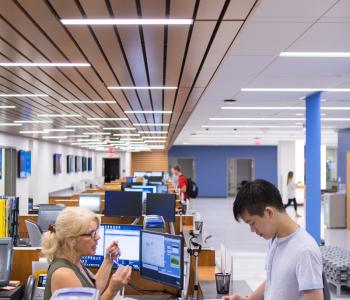 A student talking with an associate at the UB Card section of 1Capen. Photo by Douglas Levere.