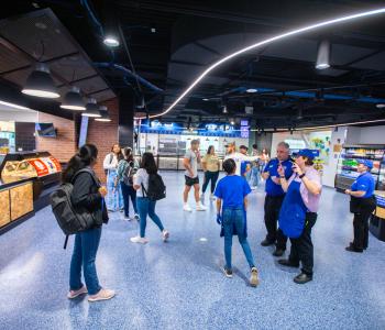 Students and associates gather in the scatter area at One World Café in front of Pan Asia.