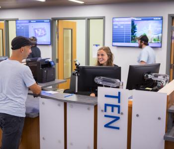 A student talking with an associate at the UB Card section of 1Capen. Photo by Meredith Forrest Kulwicki.