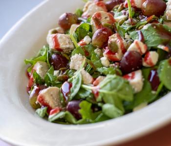 Chicken salad on a bed of spinach, with grapes, sunflower seeds and fetta, topped with a red wine vinaigrette.