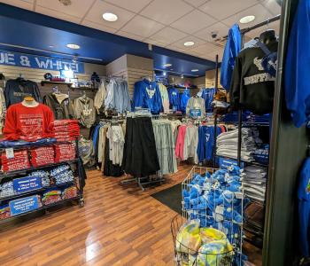 Inside of the Campus Tees store full of apparel like sweatshirts, sweatpants and Victor E. Bull plushies.