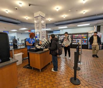 Student checking out with an associate at Capen Café in Capen Hall.