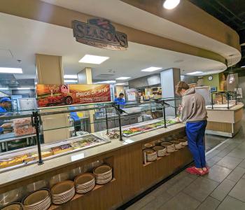 Student getting food at Seasons Salad Bar at C3.