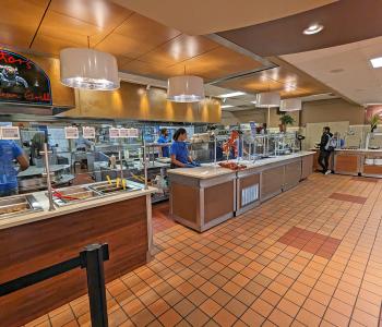 Associates prepared to serve students inside Goodyear Dining Center.