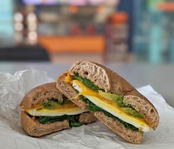 The Power Bagel, a signature breakfast sandwich only at Corner Café. The entrance to the café is in the background.